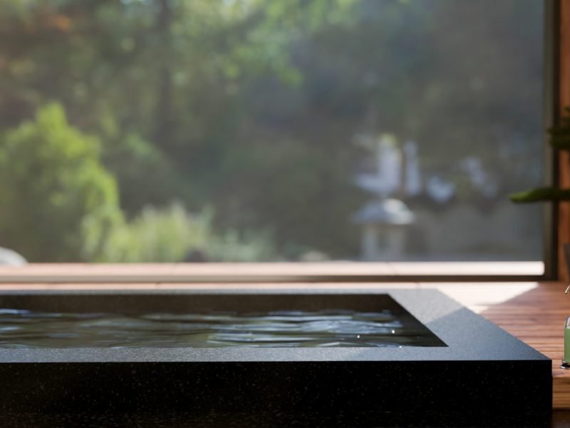 close-up image, Luxury jacuzzi tub or Japanese Onsen bath against the large glass wall