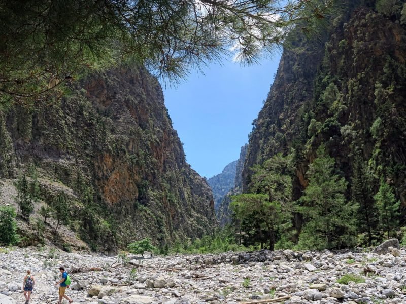 People hiking on trail through Samaria gorge. (Crete, Greece).